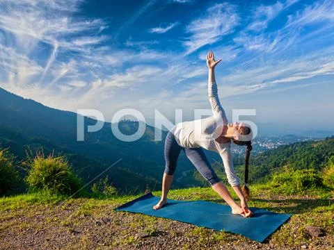 Woman doing Ashtanga Vinyasa yoga asana Utthita trikonasana Stock Photos