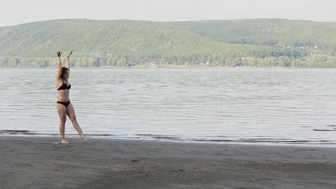 Woman Doing on beach Stock Footage 76985793