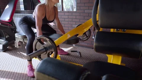 Woman doing deadlift on a exercise machine in the gym Stock Footage 80613791