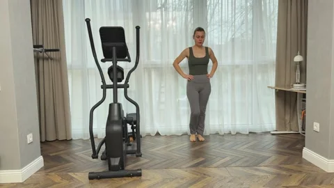 Woman doing deep forward lunges at home in living room, Concept of strength and Stock Footage 345686541