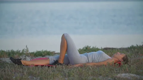 Woman doing exercise on the beach Stock Footage 116534952