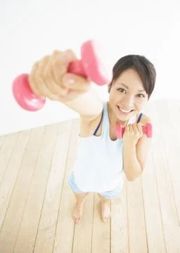 Woman doing exercise with dumbbells Stock Photos