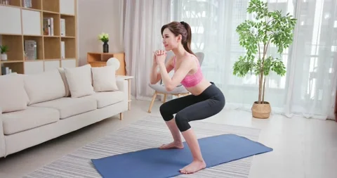 Woman doing exercise at home Stock Footage 136522906