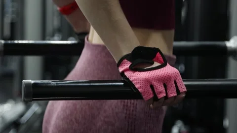 Woman doing exercise for training triceps dips on parallel bars in the gym 動画素材 278515668