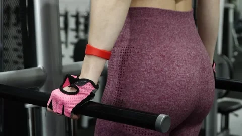 Woman doing exercise for training triceps dips on parallel bars in the gym 動画素材 278515682