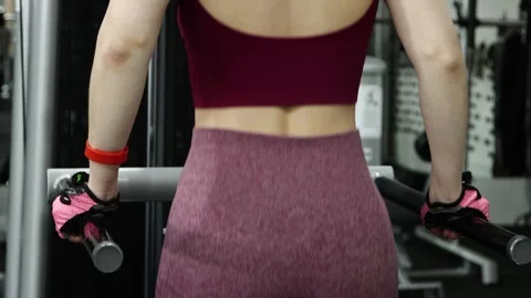 Woman doing exercise for training triceps dips on parallel bars in the gym Stock-Footage 278515765