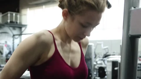 Woman doing exercise for training triceps dips on parallel bars in the gym 動画素材 278515821