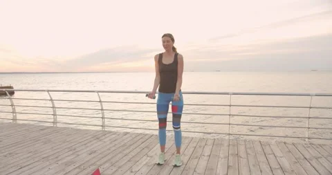 Woman doing exercises for core and upper body strength outdoors Stock Footage 137341802