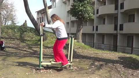 Woman doing exercises on trainer Stock Footage 61769206