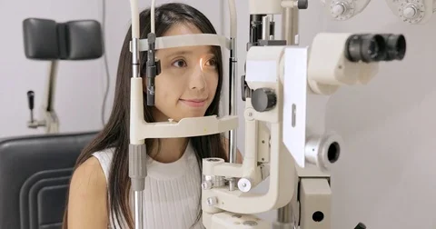 Woman doing eye test at the clinic Stock Footage