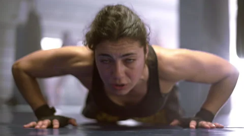 Woman doing flexing exercise in boxing club Stock Footage 50388897