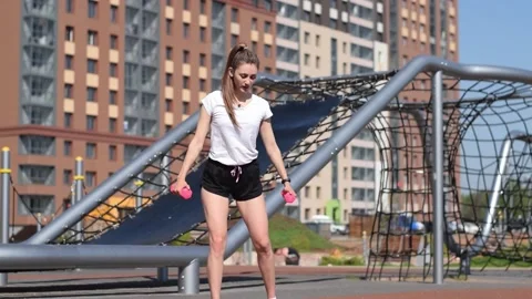 Woman doing a functional workout with cross lunges and dumbbells Stock Footage 154846139