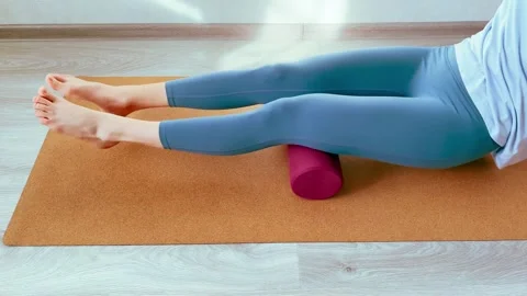Woman doing hamstrings myofascial release with foam roller Stock Footage 344302198