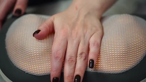 Woman doing hand massage using automatic close up Stock Footage 307209829