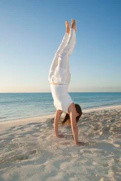 Woman doing Handstand on Beach, Reef Playacar Resort and Spa, Playa del Carmen, Stock Photos