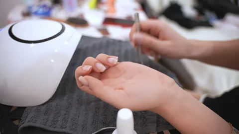 Woman doing her nails at home applying t... | Stock Video | Pond5