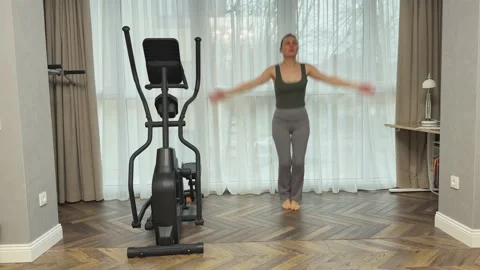 Woman doing jumping jacks at home with arm claps overhead, Concept of full body Video stock 341866780