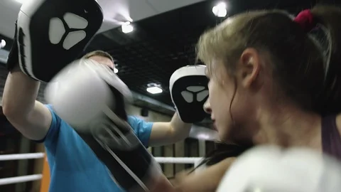 Woman is doing kickboxing training to practicing hand punches in gloves in gym. Stock Footage 107183528