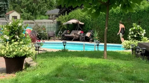 Woman Doing Laps Around the Pool Stock Footage 156354086