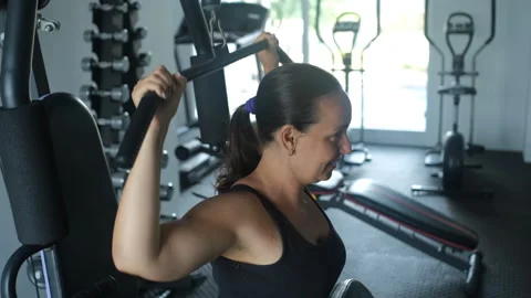 Woman doing lat pulldown behind neck at gym Stock-Footage 335256001
