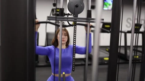 Woman doing lat pulldown in gym Stock Footage 328995887