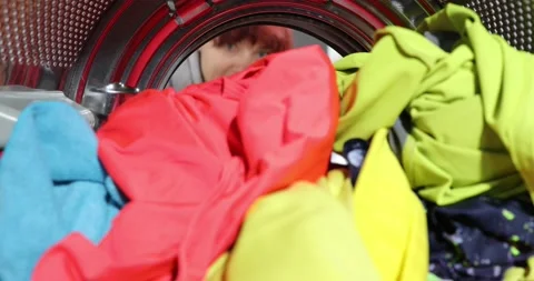 Woman doing laundry. View Looking Out From Inside Washing Machine As Woman Ta Stock Footage 152855942