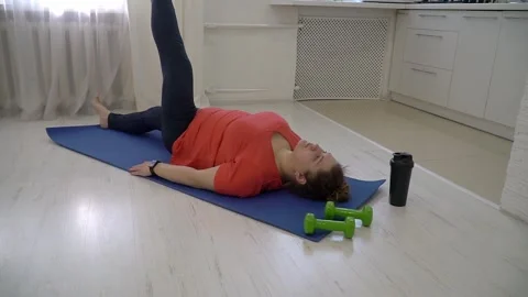 Woman Doing Leg Exercise on Blue Yoga Mat at Home, Healthy Fitness Routine 動画素材 328303472