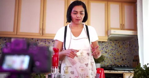 Woman doing live stream while cooking fruits, wide shoot Stock-Footage 142597237