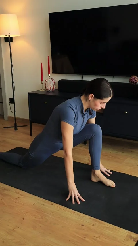 Woman doing lunge to hamstring stretch flow on yoga mat Stock Footage 322163888