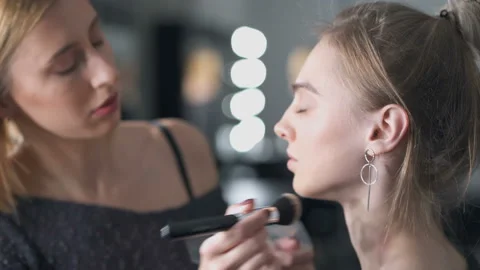 Woman doing make up to the model. Stock Footage 121511907