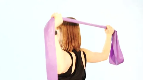 Woman is doing physical exercises for developing muscles of hands and back. Stock Footage 104844748