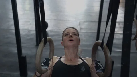 Woman doing pull-ups on gymnastic rings Stock-Footage 106493621