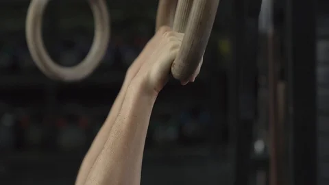 Woman doing pull-ups on gymnastic rings Stock-Footage 106493644