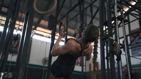Woman doing pull-ups on gymnastic rings Stock-Footage 106493667