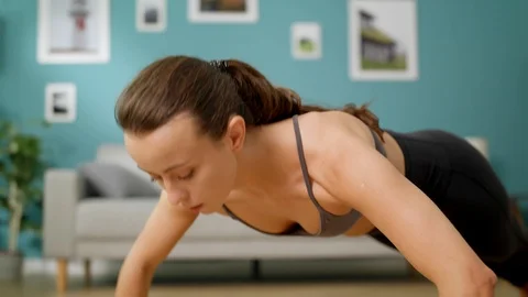 Woman doing push up exercise at living room Stock Footage 113858951