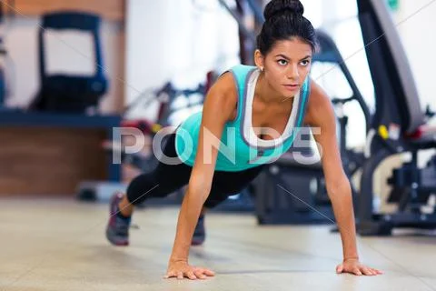 Woman doing push ups in gym Stock Photos