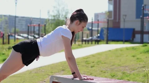 Woman doing a push ups on the playground. Stock Footage 154846389