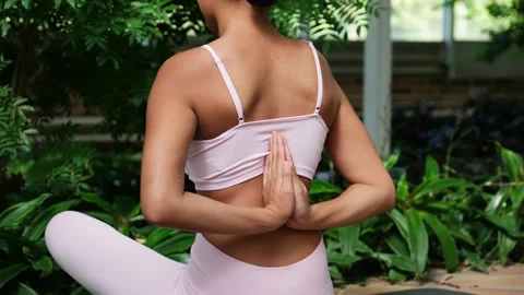 Woman doing a reverse prayer yoga pose Stock-Footage 340554299