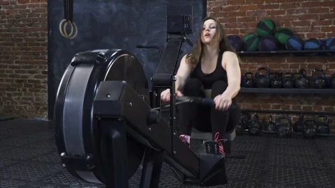 Woman doing rowing machine workout Stock Footage 72888855