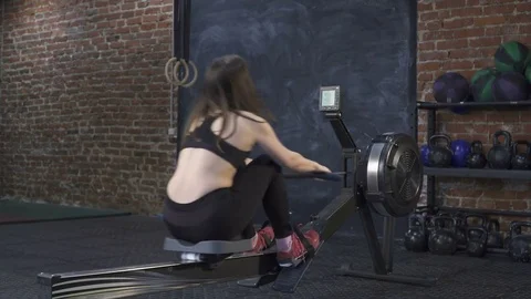 Woman doing rowing machine workout at gym Stock Footage 72888904