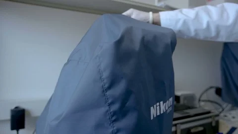 Woman doing science test with a microscope at her workplace, open Stock Footage 75451868