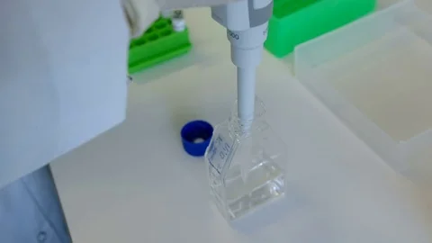 Woman doing science test with some bottles at her workplace, close Stock Footage 75444833