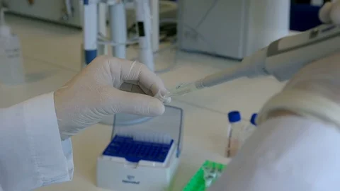 Woman doing science test with some bottles at her workplace, hands Stock Footage 75444851