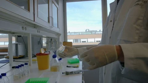 Woman doing science test with some bottles at her workplace, wide Stock Footage 75452119