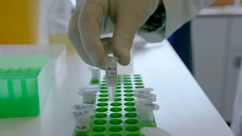 Woman doing science test with some bottles at her workplace, one Stock Footage 75452153