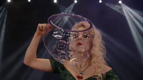Woman is doing soap bubble show on the black background Stock-Footage 70134283