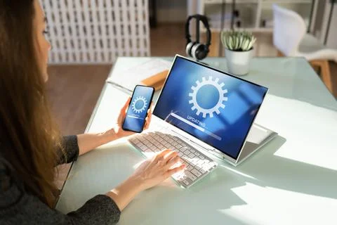 Woman Doing Software Update On Mobile Phone Foto stock
