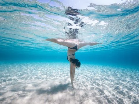 Woman doing split dance overturned underwater sports dance Stock Photos