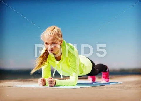 Woman doing sports outdoors Stock Photos