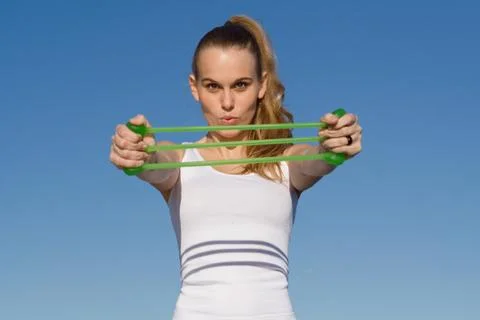Woman doing strength exercises with elastics Stock Photos